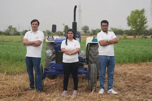 Rural Indian villagers standing together in an agricultural field, representing community strength